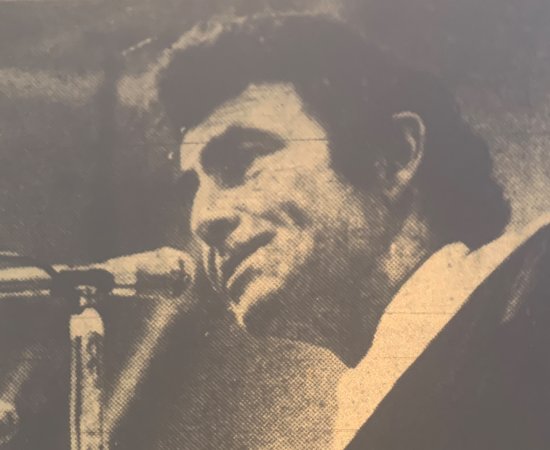 Legendary writer Rod Serling behind a microphone as he addresses the Utica Class of 1973.